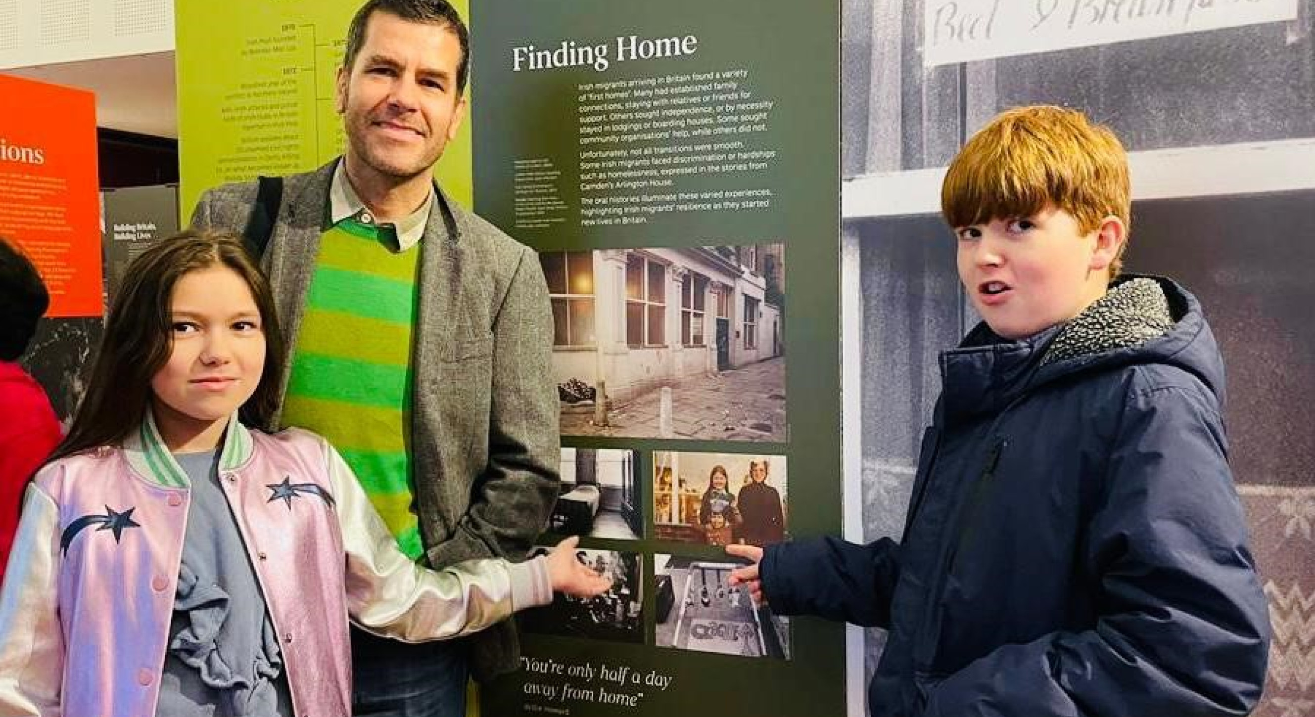 It's a family affair: Rob with his two children pointing to an image of their dad as a young boy